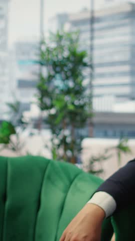 Vertical Video Male corporate leader buries his face in his hands due to frustration, pressure of a declining economy and battling the stress of a failing company. Business downfall and bankruptcy
