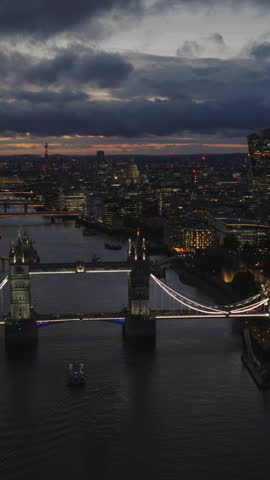 Vertical establishing aerial view of London at night. Beautiful illuminated skyline of the capital of the United Kingdom