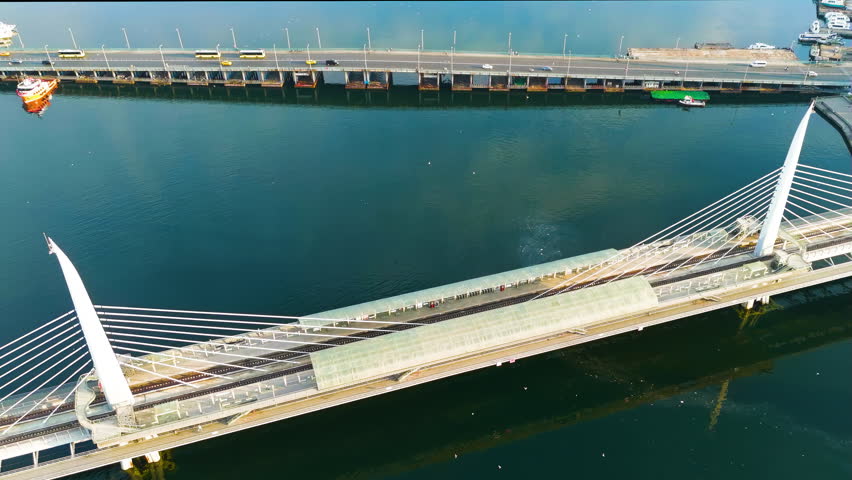 Istanbul, Turkey. Aerial view of Golden Horn Bridge and Halic Metro Station pedestrian crossing over the bay in morning sunlight. Stable, Aerial View, Point of interest. Rich colors