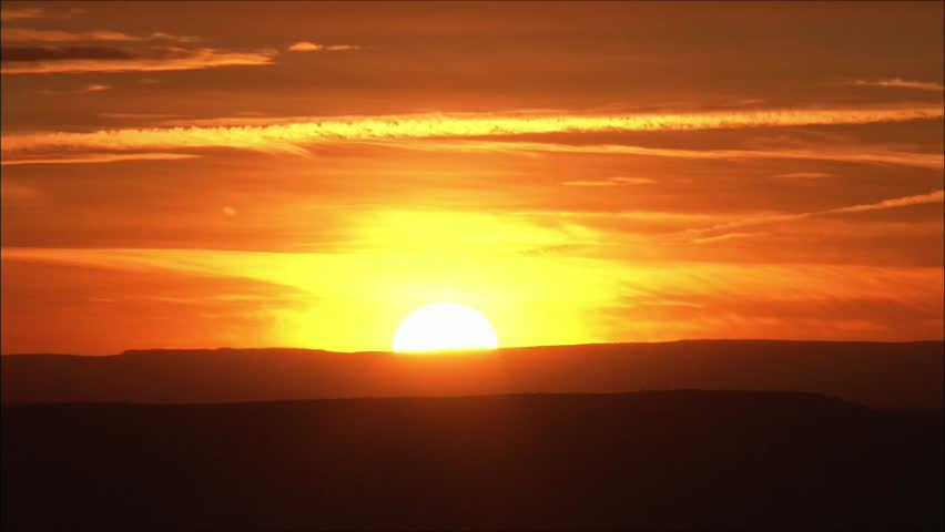 Golden Desert Sunset Over a Quiet Horizon At Dusk With Warm Orange Sky
