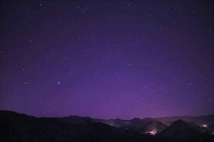 Purple Night Sky Over Mountain Ridge With Bright Moon and Starry Stars Landscape