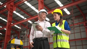 Senior engineers and young female workers are talking and inspecting machines on a production line with safety helmets and other equipment - Powered by Shutterstock - Get 15% off with code: PIKWIZARD15