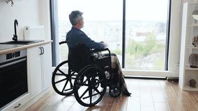 Senior man sitting in wheelchair gazing outside through window, embracing tranquility. Indoor setting with focus on accessibility, lifestyle, and reflective moment. - Powered by Shutterstock - Get 15% off with code: PIKWIZARD15