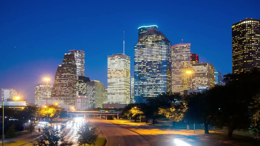 Illuminated skyscrapers dominate the houston skyline at twilight