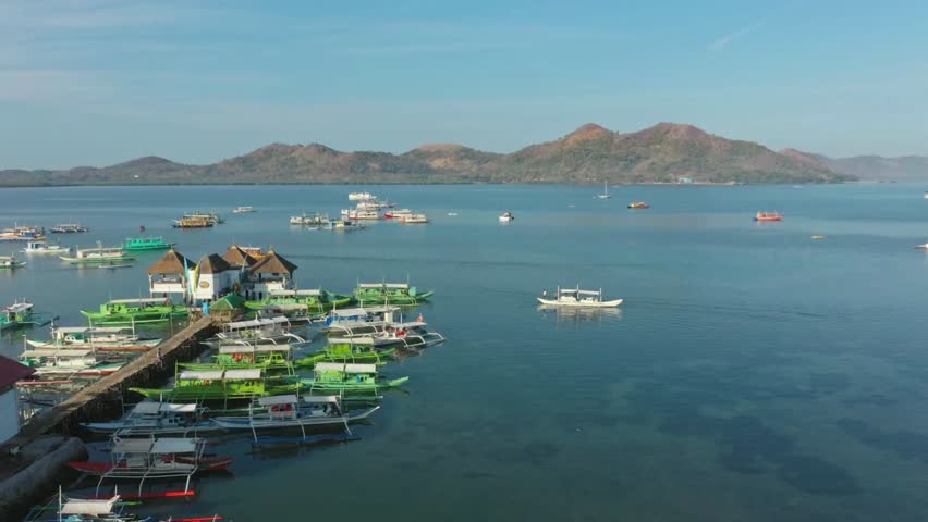Boats are docked near a small island in coron, palawan, philippines