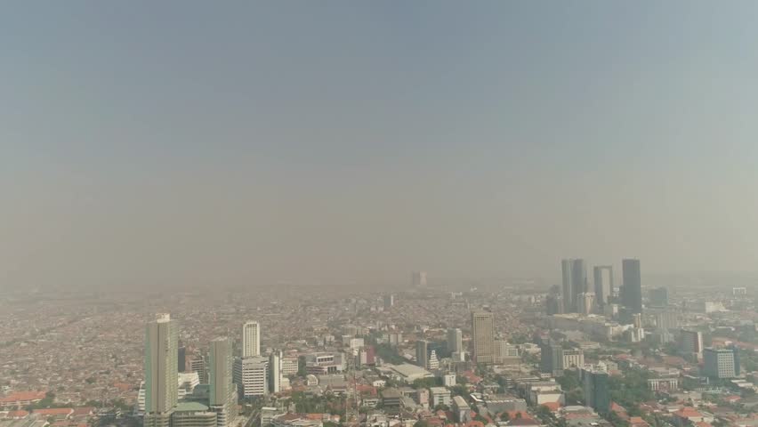 Cityscape of jakarta shrouded in smog and haze, indonesia