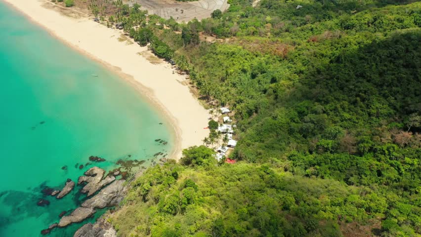 Tropical beach paradise with turquoise water and lush greenery