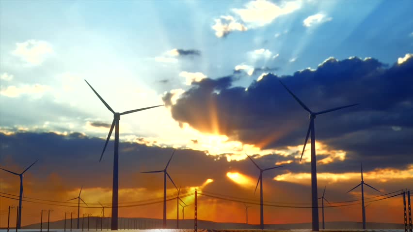Wind Turbines Silhouetted Against a Vibrant Sunset with Dramatic Clouds and Sun Rays
