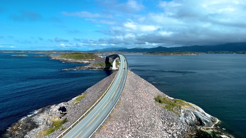 Experience the breathtaking Atlantic Ocean Road in Norway, where a scenic highway curves gracefully over stunning coastal landscapes and vibrant blue waters.