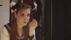 Young woman in cosplay costume applying mascara - Powered by Shutterstock - Get 15% off with code: PIKWIZARD15
