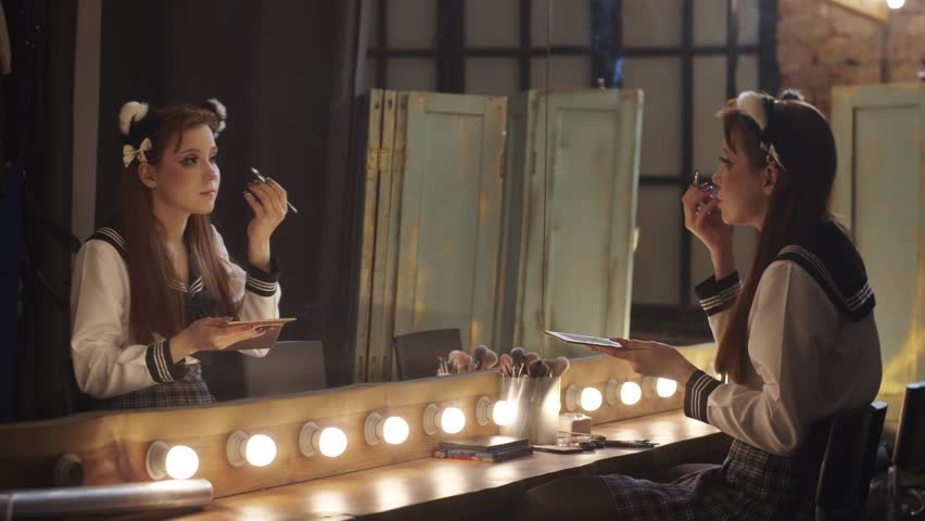 Young woman in cosplay costume applying makeup