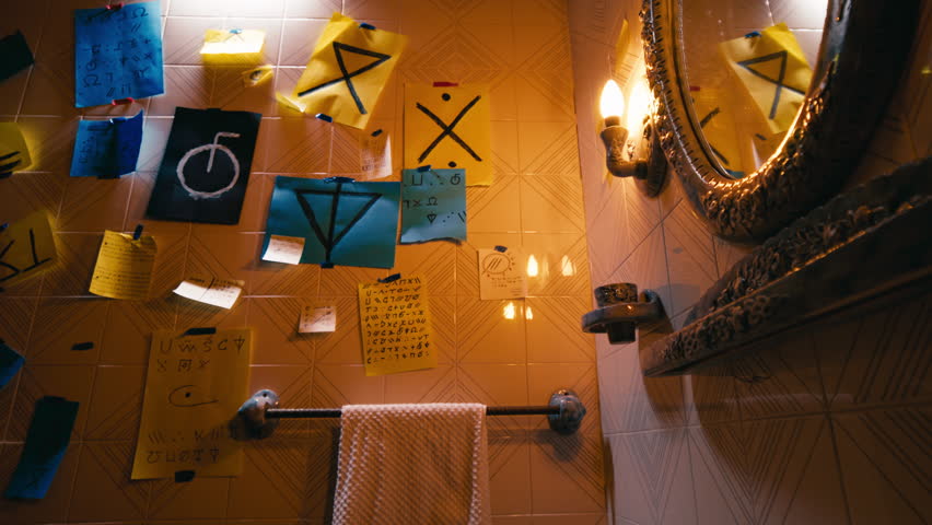 Notes with strange mystical symbols on the bathroom wall