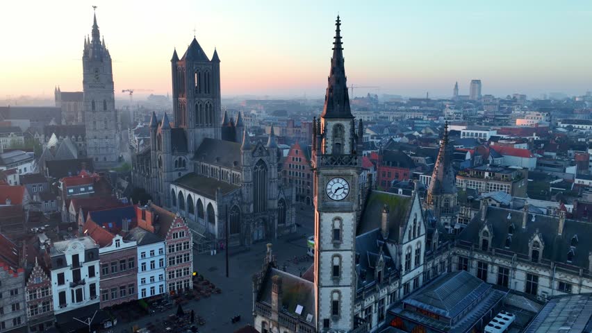 Ghent old town at sunrise, travel in Belgium, drone shot of Belgian medieval town of Ghent with gothic cathedrals in the morning. High quality 4k footage