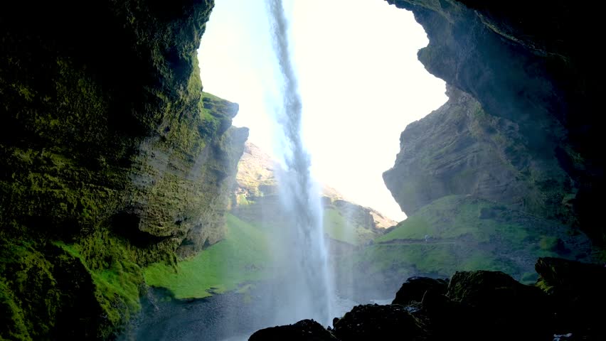 Experience the breathtaking beauty of Kvernufoss, a stunning waterfall cascading through rocky cliffs in Iceland. The vibrant greenery surrounding its base creates a picturesque nature scene.