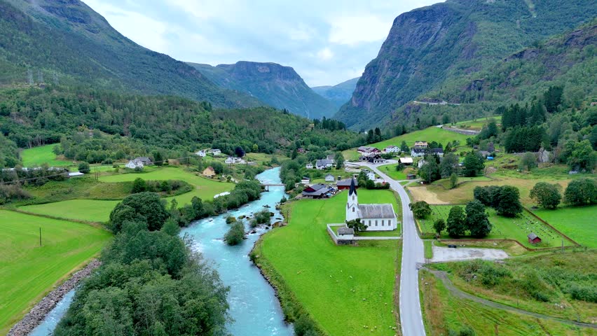 Nestled in the heart of Norway, Fortun offers breathtaking vistas of verdant valleys and towering mountains. A peaceful river flows through the charming village, highlighting its natural beauty.