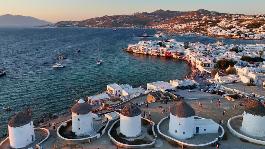 vacation on the Greek island of Mykonos, aerial view of the port and harbour at sunset. High quality 4k footage