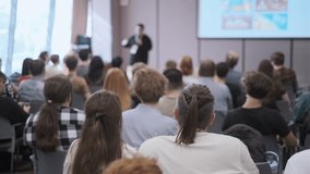 People gathered in a conference room listening to a speaker during a business presentation. Modern environment highlighting collaboration and learning atmosphere. - Powered by Shutterstock - Get 15% off with code: PIKWIZARD15