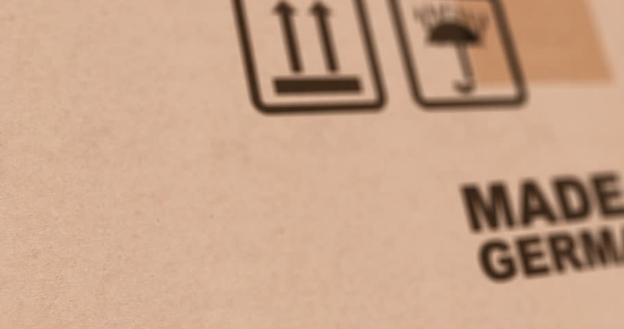 Made in Germany, stamp on cardboard package box, close up zoom, produced in Deutschland mark, footage