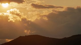 Sunset Behind Mountain with Sunbeams Through Clouds - Powered by Shutterstock - Get 15% off with code: PIKWIZARD15