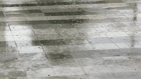 Wet pavement tiles under heavy rain with reflections and raindrops creating abstract minimalist background - Powered by Shutterstock - Get 15% off with code: PIKWIZARD15