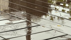 Close up of Wet wooden planks at outdoor cafe under heavy rain with reflections and raindrops creating minimal abstract background - Powered by Shutterstock - Get 15% off with code: PIKWIZARD15