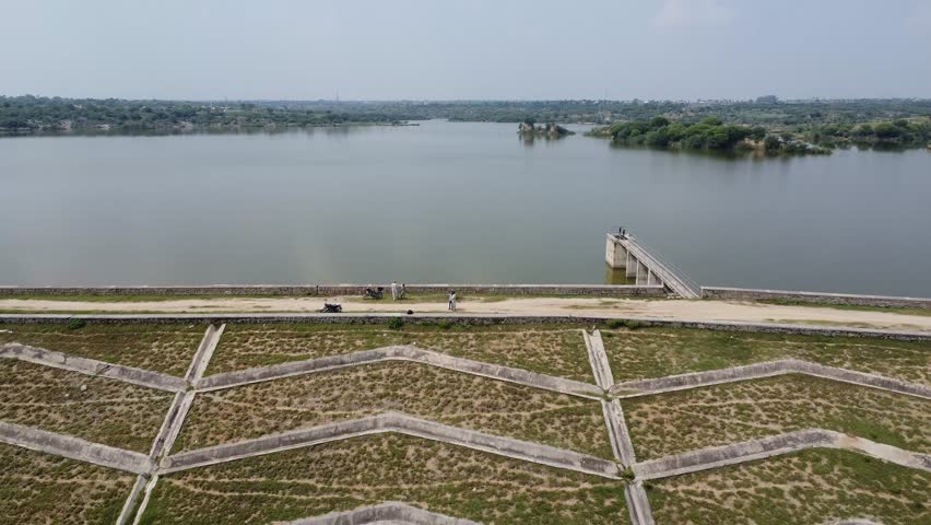 Panoramic view of small dam lake in countryside showing water reservoir built for irrigation and scenic landscape
