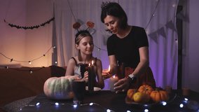 Mother Teaching Daughter To Light Up Halloween Candles In A Decorated Room - Powered by Shutterstock - Get 15% off with code: PIKWIZARD15
