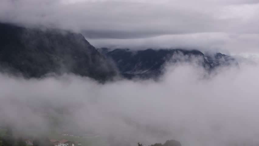 Scenic view of dramatic clouds over Swiss alpine lakes near Lake Thun. Stunning mountain landscape with reflections on the water, peaceful atmosphere, and natural beauty of Switzerland. Perfect for tr