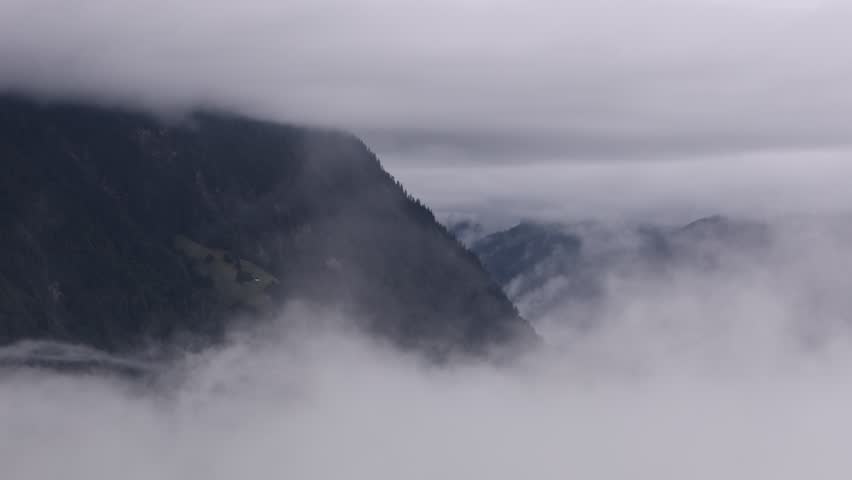 Scenic view of dramatic clouds over Swiss alpine lakes near Lake Thun. Stunning mountain landscape with reflections on the water, peaceful atmosphere, and natural beauty of Switzerland. Perfect for tr