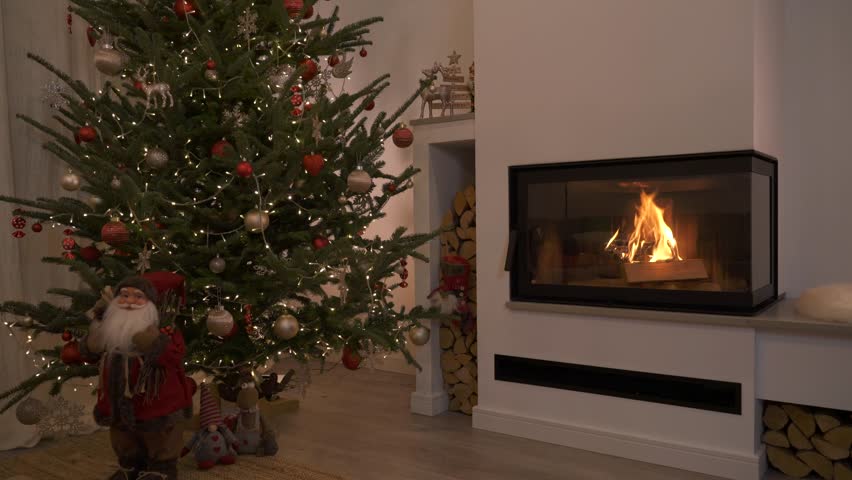 Cozy Fireplace with Burning Wood and Christmas Tree Decorations
