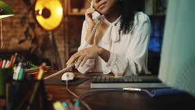 Female manager in retro clothes flirting on phone call at vintage office job - Powered by Shutterstock - Get 15% off with code: PIKWIZARD15