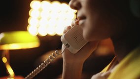 Close-up of happy young woman talking on landline phone, receiving good news - Powered by Shutterstock - Get 15% off with code: PIKWIZARD15