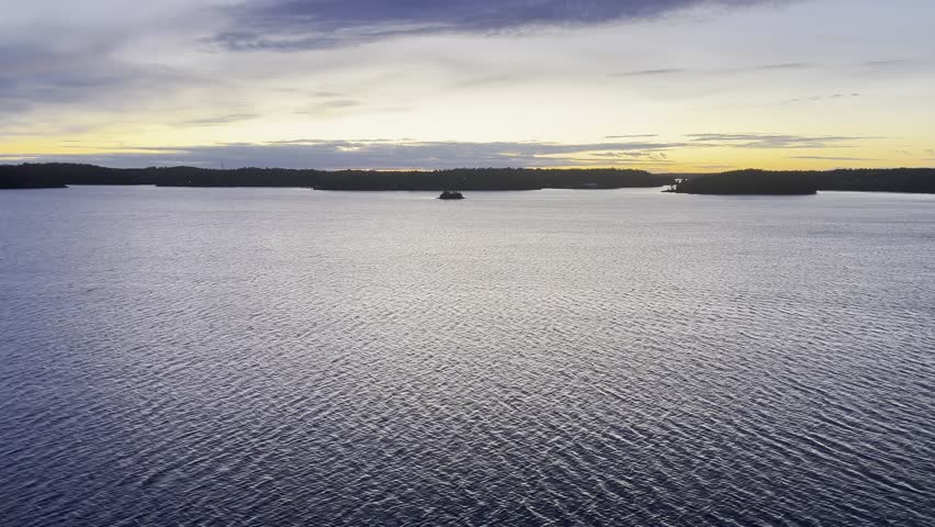 water surface, a boat crosses the frame