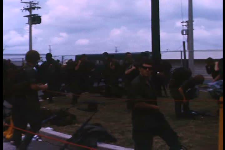 1970s - U.S. soldiers at Bien Hoa airbase in Vietnam boarding transport plane and bombs are loaded.