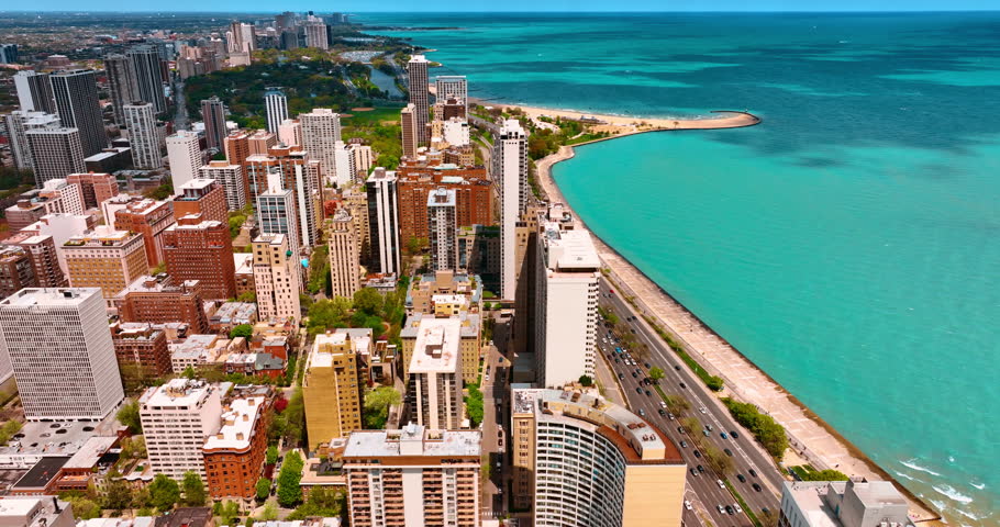 View on Chicago and stunning Lake Shore Drive on sunny day. Iconic panorama of Chicago, Illinois, USA and waterscape of Lake Michigan from drone.