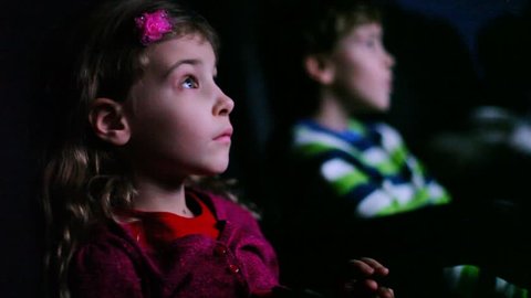Boy and girl sitting in movie theater 