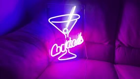 Purple and blue neon cocktails sign on sofa  - Powered by Shutterstock - Get 15% off with code: PIKWIZARD15