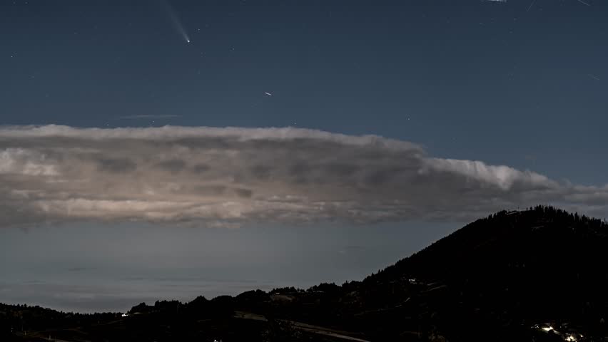 Comet and Stars Above Clouds in Blue Night Sky Astronomy Time-Lapse