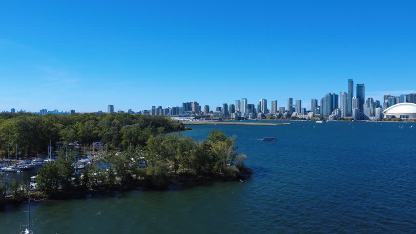 Beautiful aerial drone footage of Toronto Island marina with a clear view of the Toronto city skyline. Captured in 4K UHD ProRes, showcasing boats, waterfront, and the urban landscape.