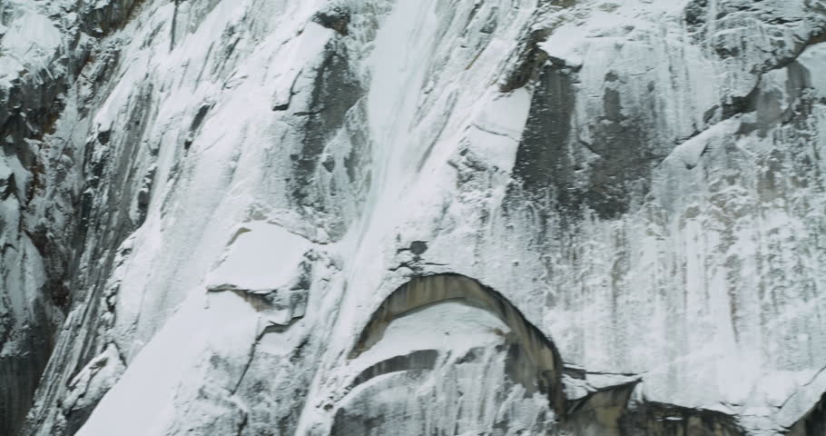 Flying close to snowy peaks and the river formed by the melting waters of a glacier in Denali National Park, Alaska. 