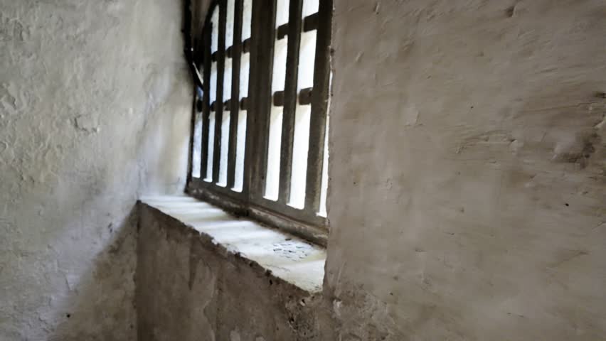 Inside the stone cave, sunlight filters through the ancient stone window, with a pile of coins scattered on the windowsill.