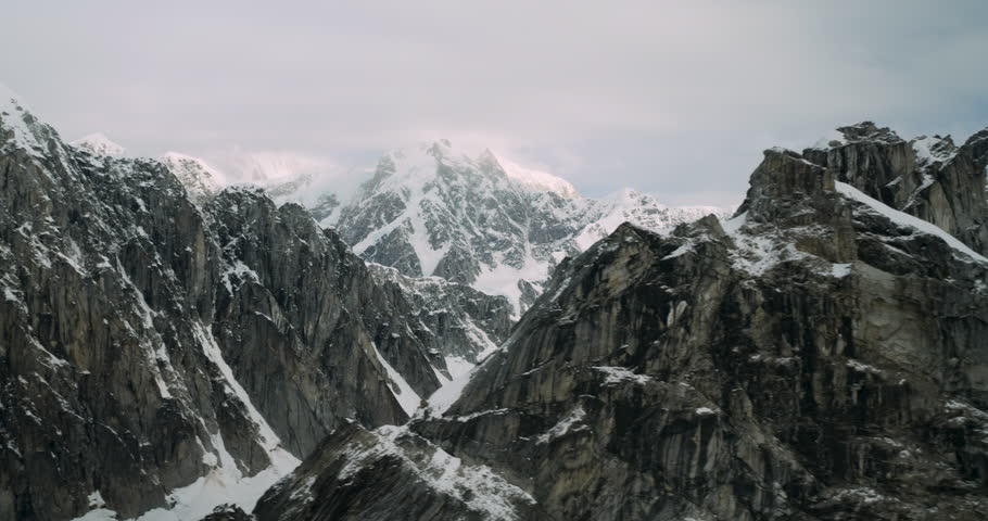 Flying along snowy mountains in small plane along Denali National Park, Alaska