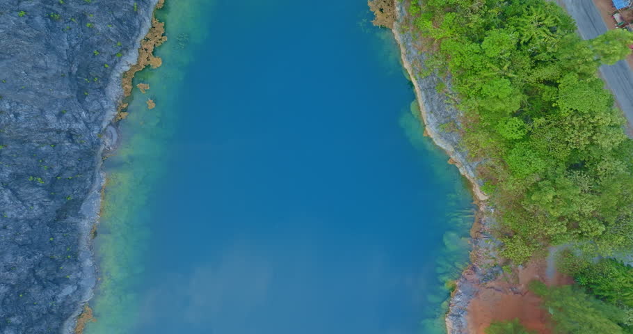 Aerial view large pond There is blue water and the pine forest has a beautiful view like Switzerland.
beautiful The reflection of the blue sky in the emerald green pond. 
Emerald green background.