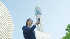 Female business person using a smartphone in the city - Powered by Shutterstock - Get 15% off with code: PIKWIZARD15