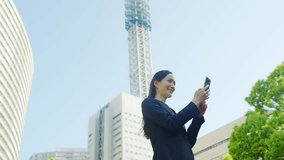 Female business person using a smartphone in the city - Powered by Shutterstock - Get 15% off with code: PIKWIZARD15