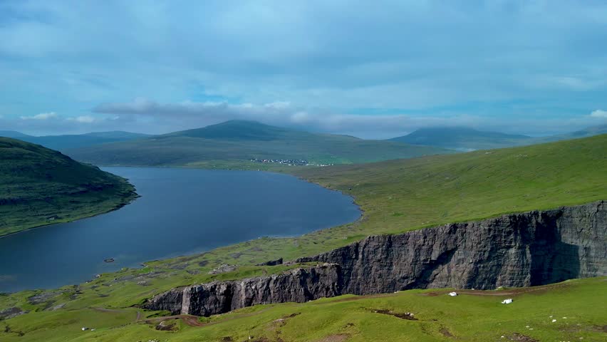 Breathtaking views of the serene waters and lush green hills in the Faroe Islands. Sorvagsvatn lake, Vagar