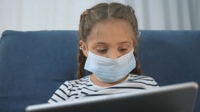 Child girl wearing mask uses tablet screen while sitting on couch at home with braided hair and focused expression learning and study activity promoting health and safety awareness mask learning focus - Powered by Shutterstock - Get 15% off with code: PIKWIZARD15