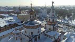 Flight orbit Epiphany Cathedral's colorful domes and ornate facade in Irkutsk. Winter drone flight circling the historic Orthodox church above snowy Angara River. Best cityscape. Siberia, Russia 4k - Powered by Shutterstock - Get 15% off with code: PIKWIZARD15