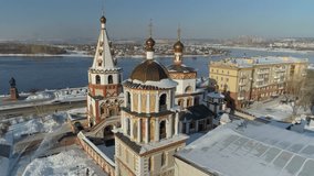 Aerial forward flight above historic Epiphany Cathedral Irkutsk, Siberia. Domes and ornate facade of Orthodox church, overlooking frozen Angara River and vast cityscape. Top Russian tourist attraction - Powered by Shutterstock - Get 15% off with code: PIKWIZARD15