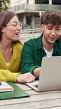 Two students working together on a laptop, studying and learning for University exams - Powered by Shutterstock - Get 15% off with code: PIKWIZARD15